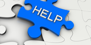 Blue puzzle piece with the word "HELP" fitting into a larger puzzle.