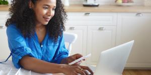 Person looking at computer. Need help with your water bill? Apply today-LIHWAP ends soon!