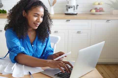 Person looking at computer. Need help with your water bill? Apply today-LIHWAP ends soon!